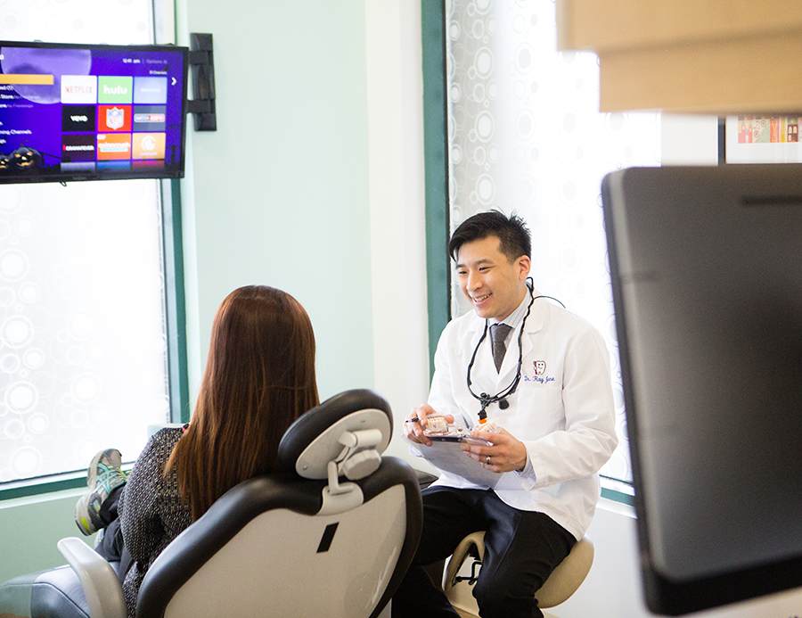 Dentist Dr. Raymond Jone consulting with a patient at Pacific Sky Dental.